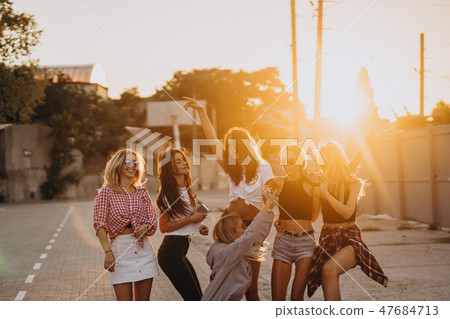 Six young women dance in a car park Six young women dance in a car park 47684713