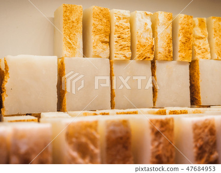 Bars of soap on a shop window. Turmeric soap with natural cedar oil and herbal ingredients. Handmade Bars of soap on a shop window. Turmeric soap with natural cedar oil and herbal ingredients. Handmade 47684953