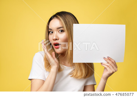 Attractive young beautiful Asian student woman holding blank white paper. Attractive young beautiful Asian student woman holding blank white paper. 47685077