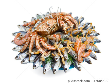 Big hairy boiled crab sits on a heap of fish Big hairy boiled crab sits on a heap of fish 47685399