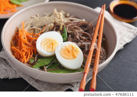Japanese soup with Enoki mushrooms, soba noodles 47686111