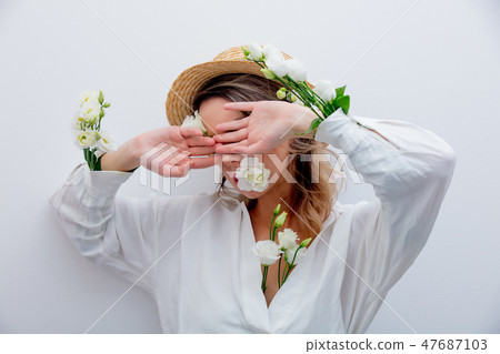 Beautiful woman with white roses in sleeves  47687103