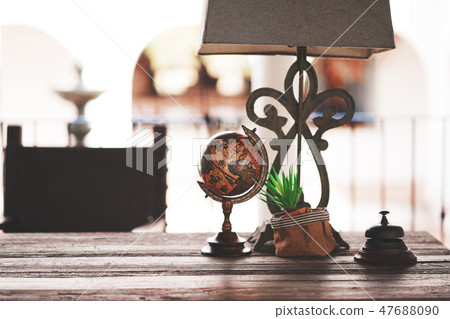 Lamps and world map placed on the old wooden table Lamps and world map placed on the old wooden table 47688090