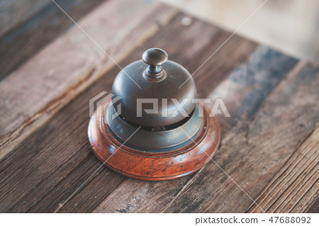 Vintage hotel reception service desk bell on table Vintage hotel reception service desk bell on table 47688092