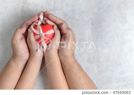 Father and child hands holding red heart Father and child hands holding red heart 47689063
