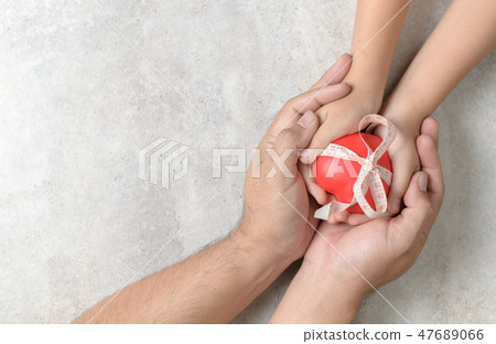 Father and child hands holding red heart Father and child hands holding red heart 47689066
