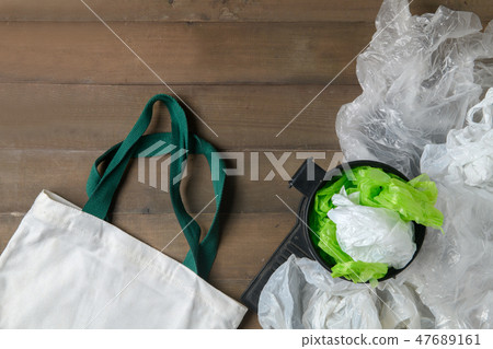 plastic bags in bin and canvas tote bag on wood plastic bags in bin and canvas tote bag on wood 47689161