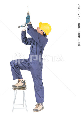 Handyman standing with his electric drill with clipping path Handyman standing with his electric drill with clipping path 47692302