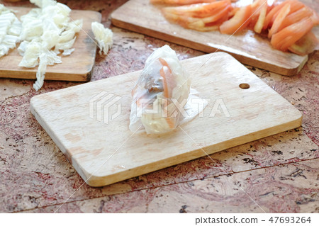 Closeup roll with rice paper, cutlet and vegetables. 47693264