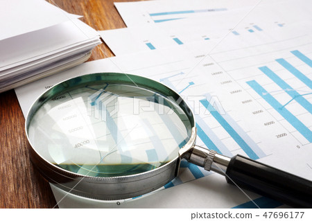Audit and accounting concept. Magnifier and papers 47696177