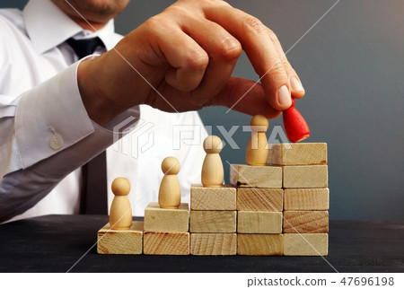 Job Promotion. Manager is holding figurine 47696198