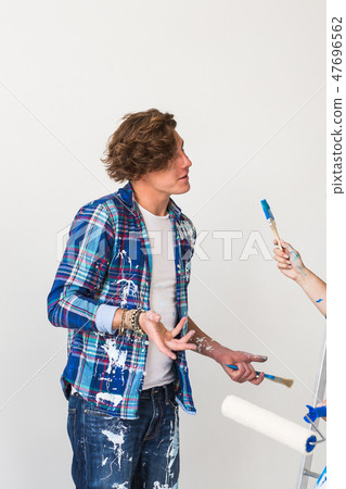 People, renovation and redecoration concept - Young woman and man discussing new apartment People, renovation and redecoration concept - Young woman and man discussing new apartment 47696562