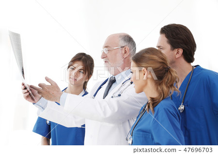 Medical team checking X-ray results Medical team checking X-ray results 47696703