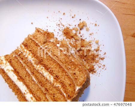 Honey cake on the white plate top view 47697048