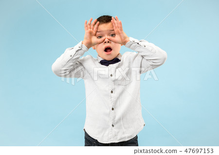 Portrait of the scared teen boy on blue 47697153