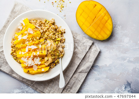 Oatmeal with mango, coconut, peanut butter 47697844