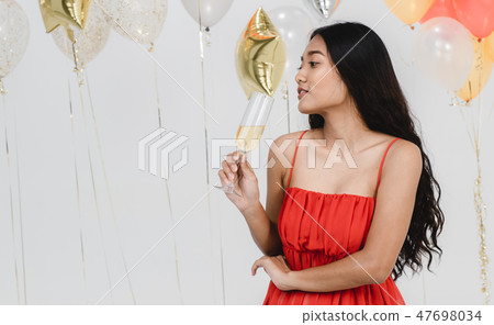 Pretty girl in red have fun at party. 47698034