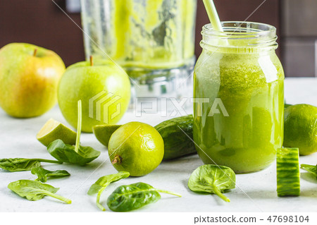 Preparation of green smoothie from spinach, apple Preparation of green smoothie from spinach, apple 47698104