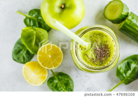 Green healthy smoothie in the jar, top view.  47698108