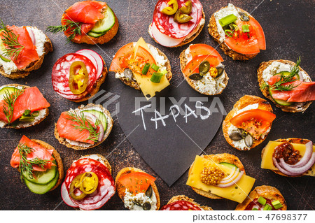 Assorted spanish tapas with fish, sausage, cheese 47698377