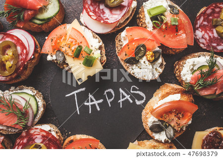 Assorted spanish tapas with fish, sausage, cheese Assorted spanish tapas with fish, sausage, cheese 47698379