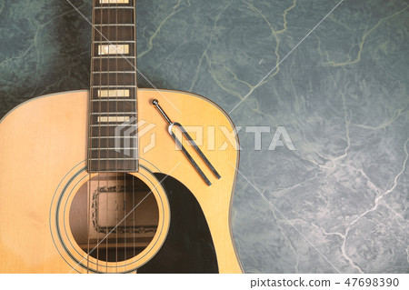 tuning fork and acoustic guitar 47698390