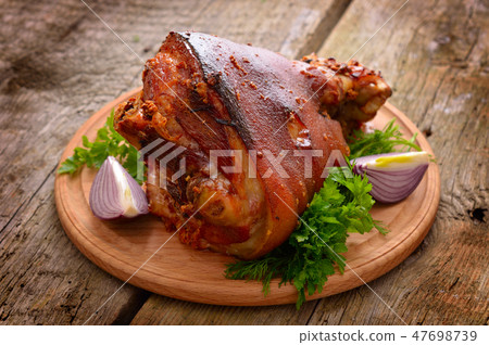 Baked Eisbein with wegetables on wooden board. Baked Eisbein with wegetables on wooden board. 47698739