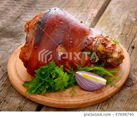 Baked Eisbein with wegetables on wooden board. Baked Eisbein with wegetables on wooden board. 47698740