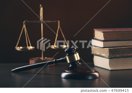 Judge gavel with Justice lawyers having team meeting at law firm in background 47699415