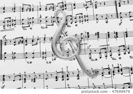 Treble clef on music sheet - musical background 47699979