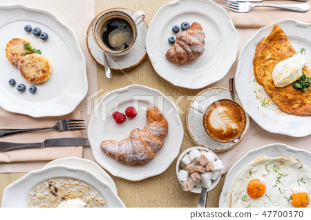 Breakfast. Croissants, coffee and many different dishes on the table in the restaurant. Frittata - Breakfast. Croissants, coffee and many different dishes on the table in the restaurant. Frittata - 47700370