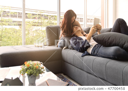 Asian teenage couple make eye contact relaxing Asian teenage couple make eye contact relaxing 47700458