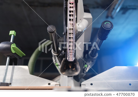 Close-up manual saw blade circular saw with plastic protection on the slides for cutting wood in the 47700870