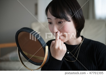 A young Japanese woman suffering from skin trouble A young Japanese woman suffering from skin trouble 47701395