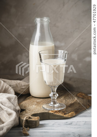 Fresh milk in glass bottle on rustic background Fresh milk in glass bottle on rustic background 47701929