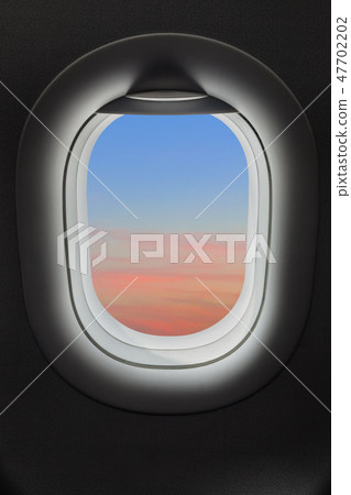 Sunset sky in airplane window 47702202
