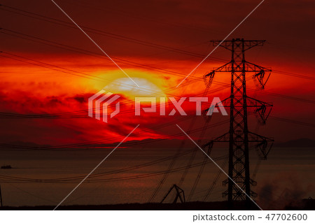 Sunset and steel tower 47702600