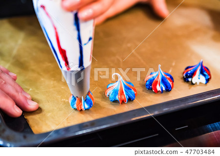Making colorful meringues with pastry bag close up 47703484