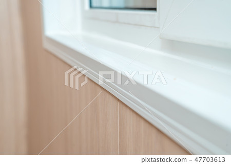Photo of a white window sill Photo of a white window sill 47703613