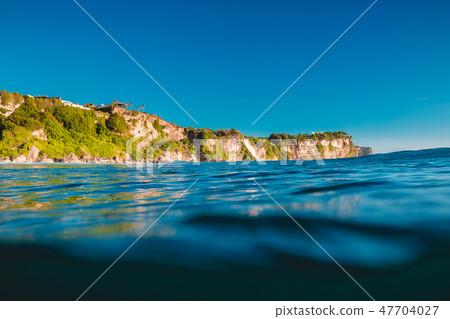 Blue ocean and cliffs in Uluwatu, Bali and sunset 47704027