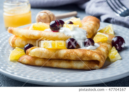 A portion of pancakes with berries and cream A portion of pancakes with berries and cream 47704167