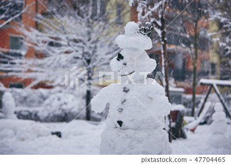 Big snowman in the city Big snowman in the city 47704465