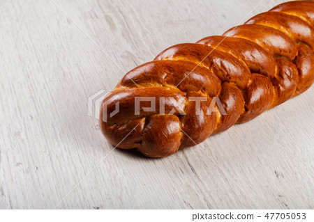 Freshly baked bread on a wooden background. Freshly baked bread on a wooden background. 47705053