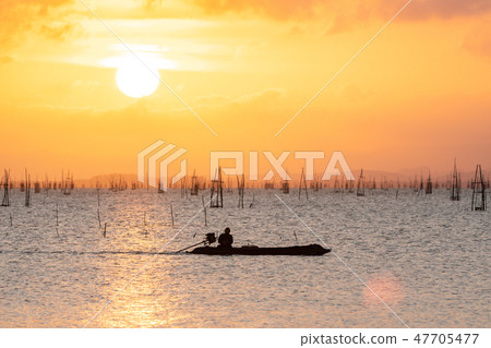 Sky orange light And fisherman boat Sky orange light And fisherman boat 47705477
