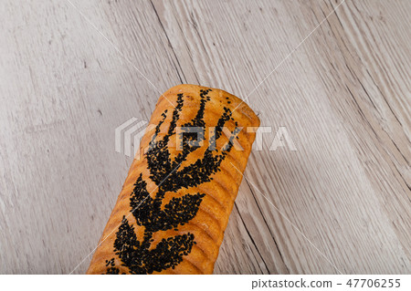 Freshly baked bread on a wooden background. Freshly baked bread on a wooden background. 47706255