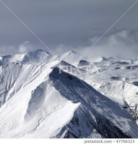 Sunlight snowy mountains in haze Sunlight snowy mountains in haze 47706323