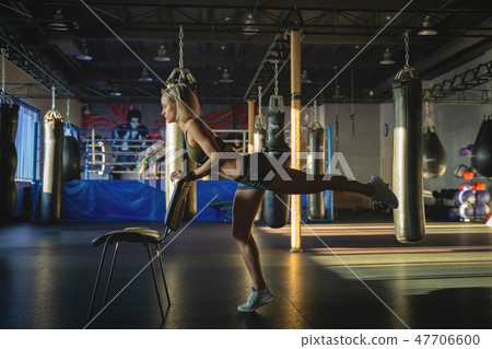 Young woman practicing yoga in gym, working out, wearing sportswear, indoor. Bodyweight exercises Young woman practicing yoga in gym, working out, wearing sportswear, indoor. Bodyweight exercises 47706600