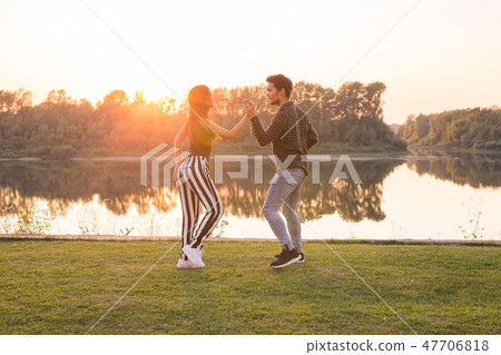 Romantic, social dance, people concept - young couple dancing near the lake in sunny day 47706818