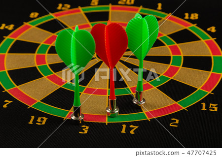 The game of darts, darts on the target. 47707425
