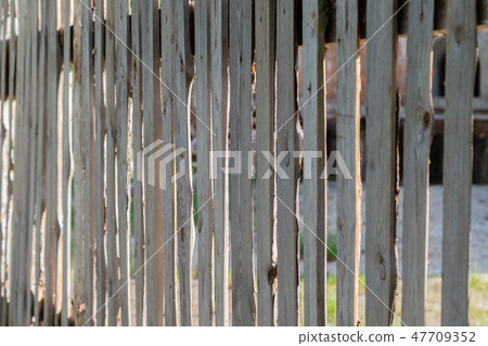Wooden peeled fence, wooden background on a sunny Wooden peeled fence, wooden background on a sunny 47709352